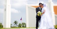 bride and groom in front of temple