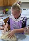 Girl kneading dough