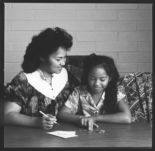 woman and daughter paying tithing