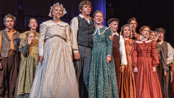 Actors in Pioneer era costume on stage. British Pageant.