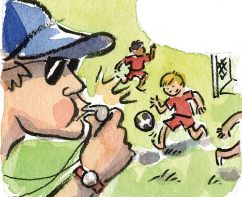 Coach blowing a whistle while kids play soccer