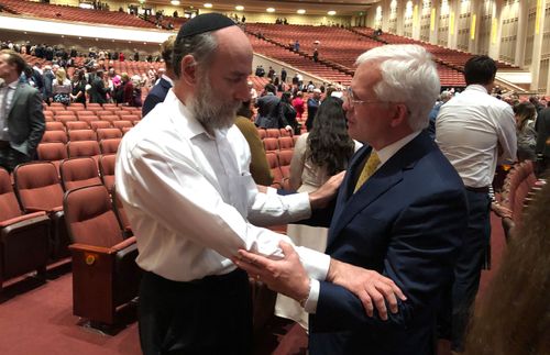 Rabbi Joe embracing Elder Carpenter at general conference