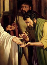 Two Apostles looking at the wounds in Jesus' hand and wrist.