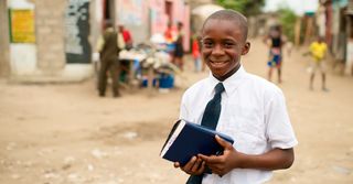 Portraits of child male holding scriptures in Congo