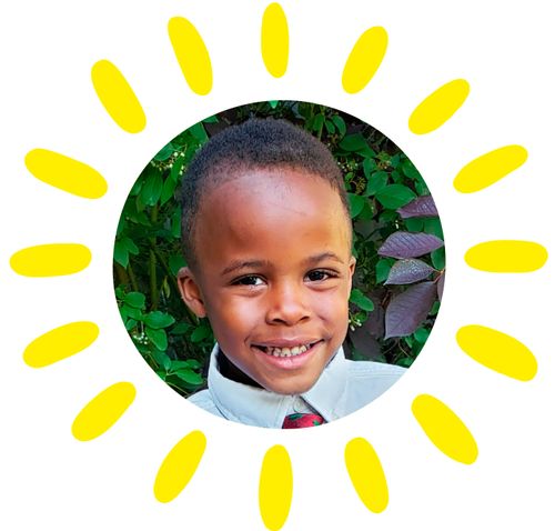 a young boy dressed in a shirt and tie stands outside in front of a tree for a picture.  He is african-american