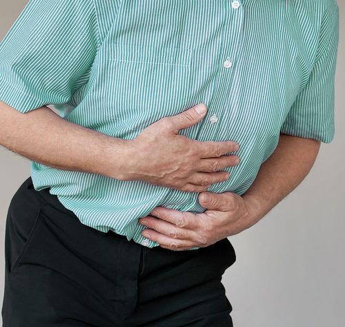 man holding sore stomach