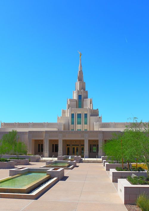 A view of the Phoenix Arizona Temple entrance, including scenery and a clear blue sky.