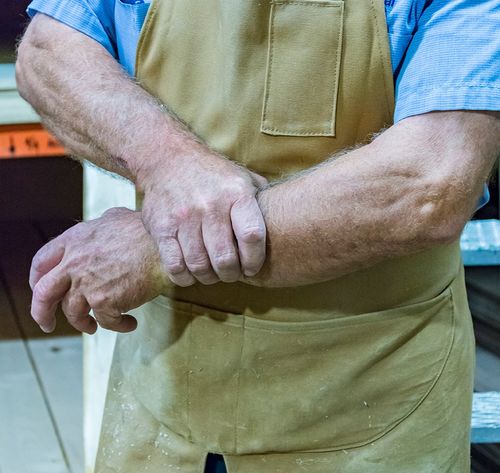 man holding injured arm