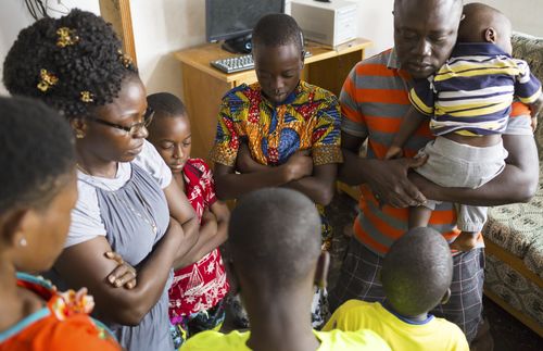 family praying together