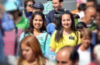 sister missionaries in crowd