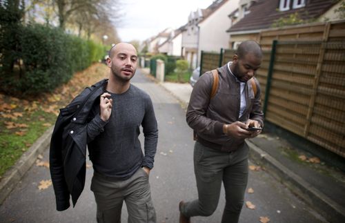 Cayo and Anthony walking down the street