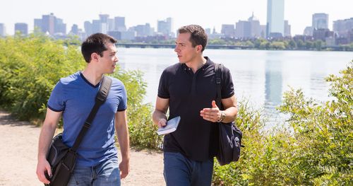 two people talking by river