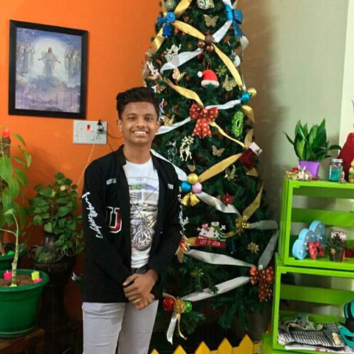 young man by Christmas tree