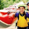 young woman helping to carry a raft