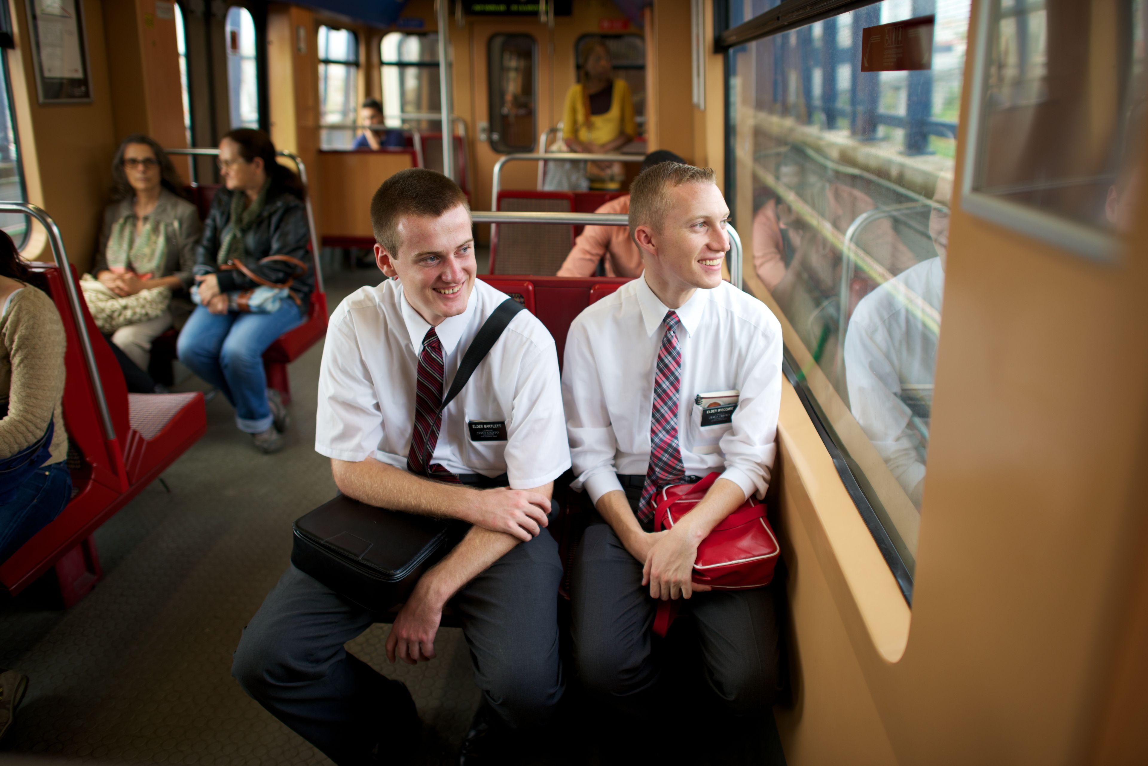 Two elder missionaries sitting on a train in Portugal.