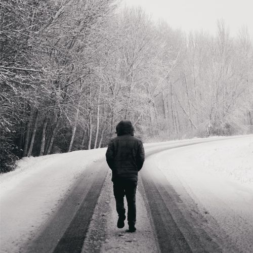 person walking down a snowy road