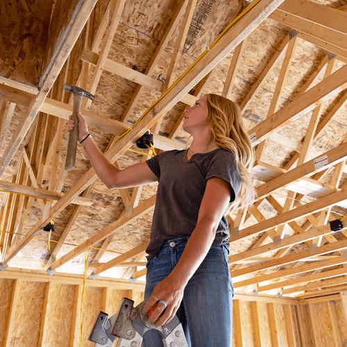 young woman hammering at construction site