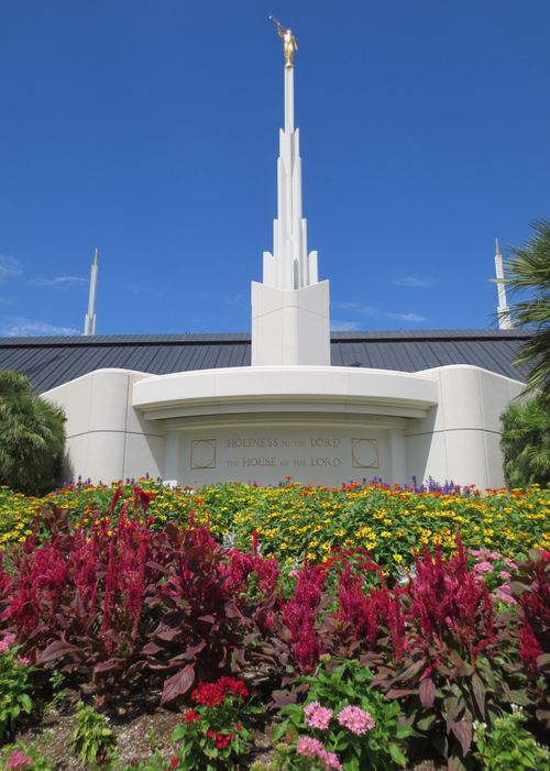 The engraving on the Las Vegas Nevada Temple that says, “Holiness to the Lord: The House of the Lord,” with flowers in the foreground.
