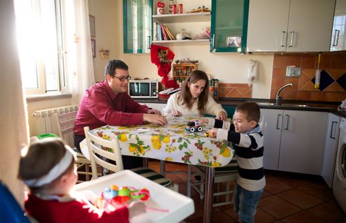 a young family sitting together at a table