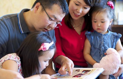 family looking at book