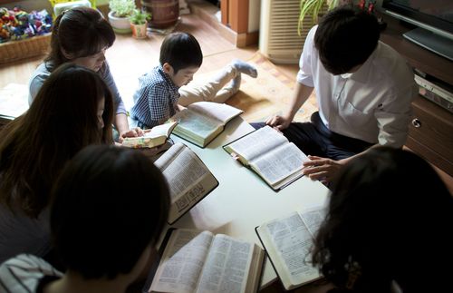 Family studying scriptures together