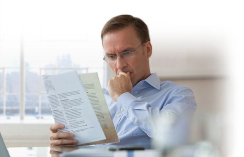 man reading magazine intently