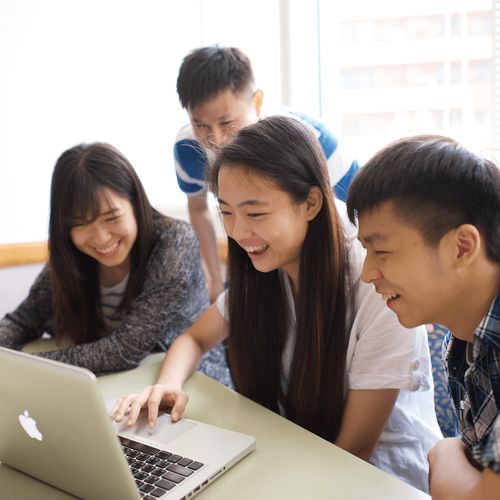 young men and young women at a computer