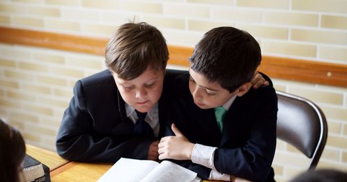 young men studying scriptures