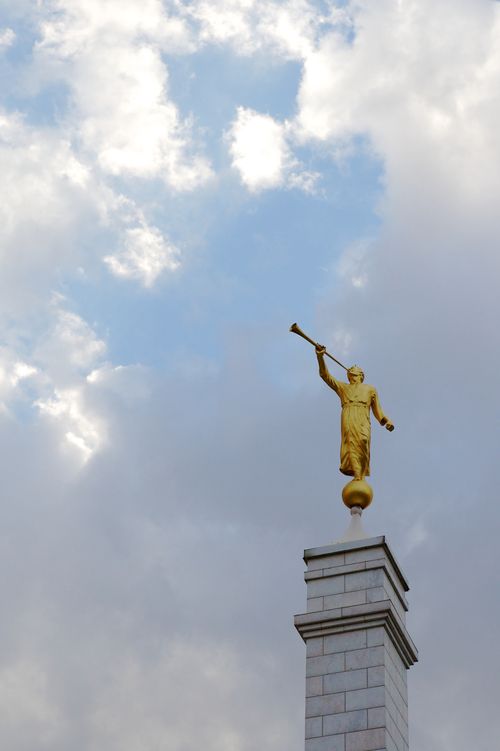 The angel Moroni on top of a gray spire at the Oaxaca, Mexico Temple on a cloudy day.