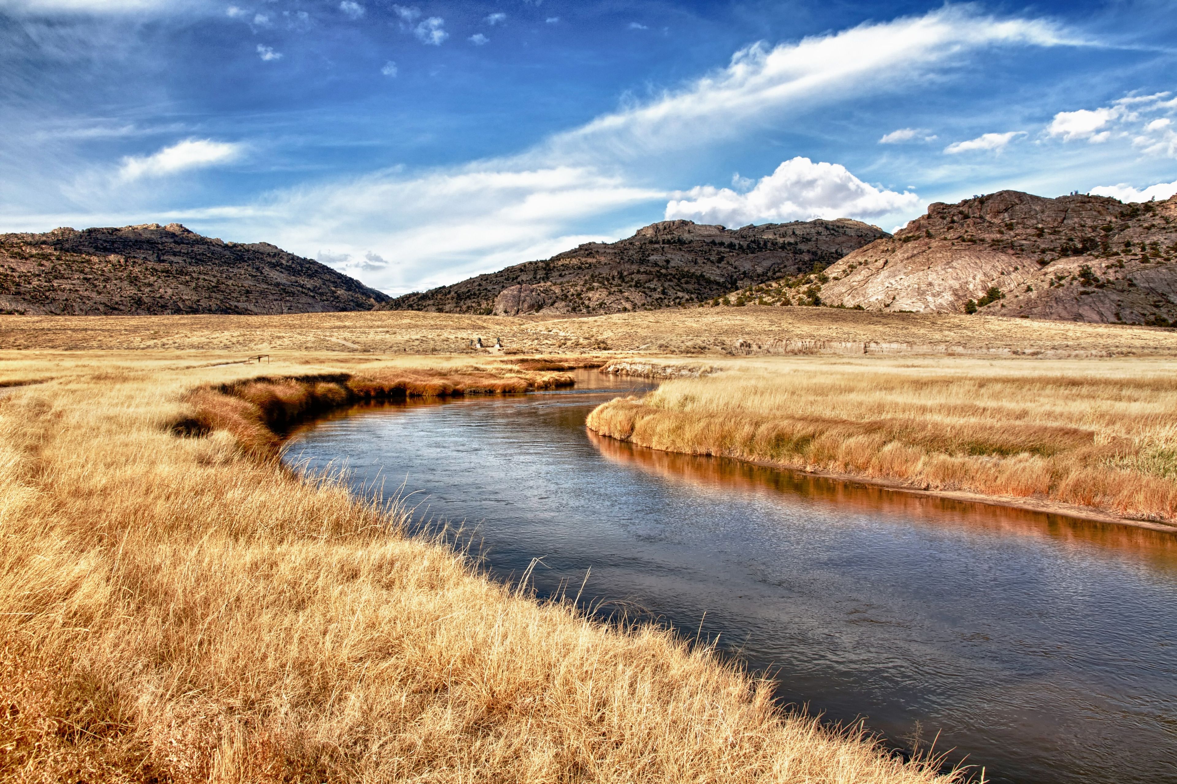 The Sweetwater River runs through a grassy meadow.