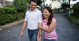 a happy married couple holding hands