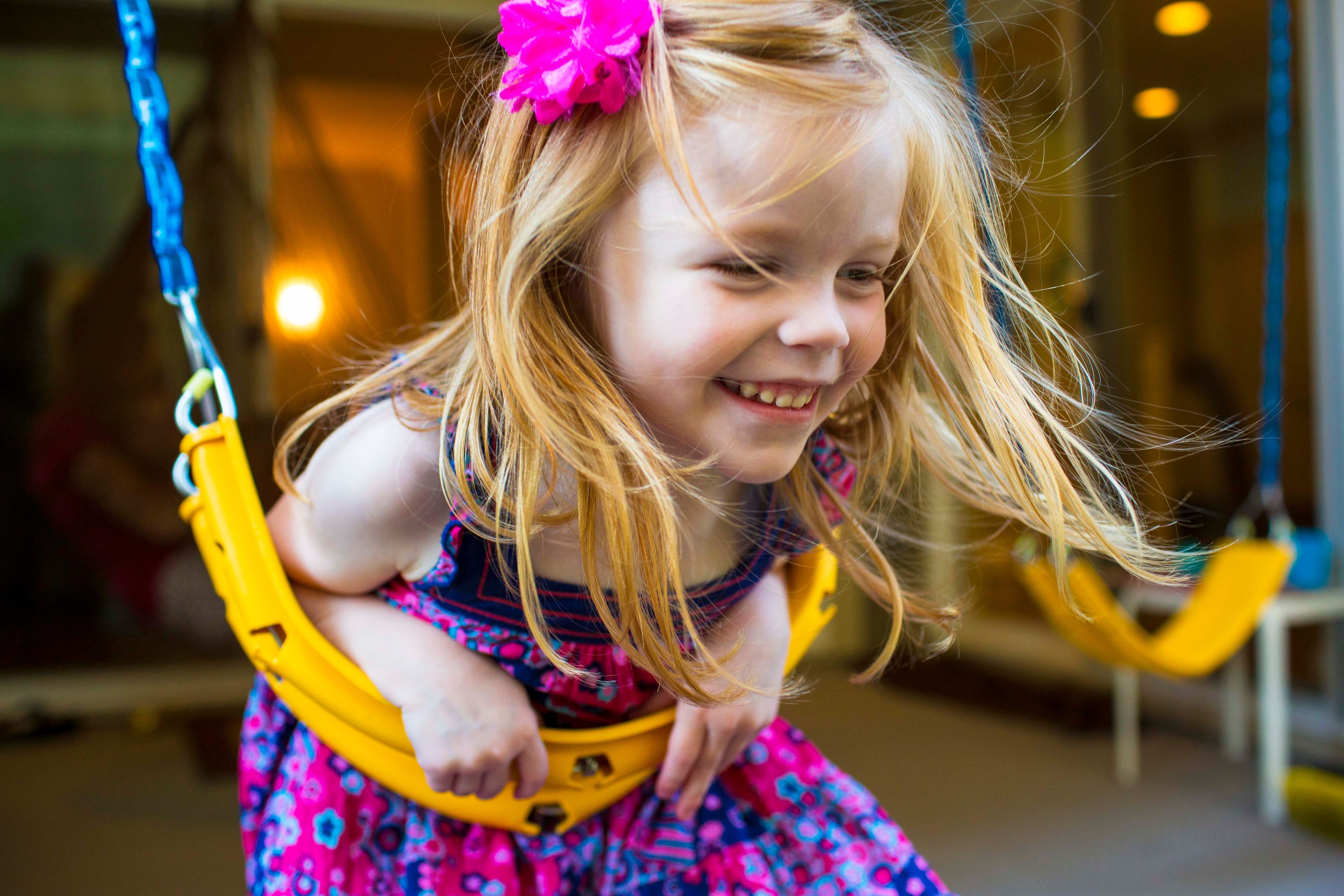 A girl swinging.  