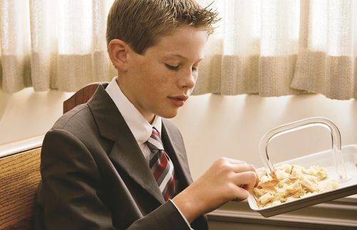 A young man taking the sacrament.