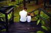 a father and a son sitting on stairs together