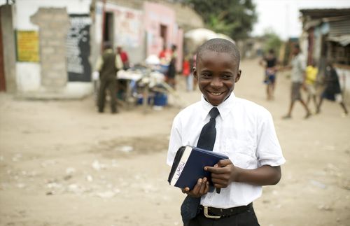 boy holding scriptures