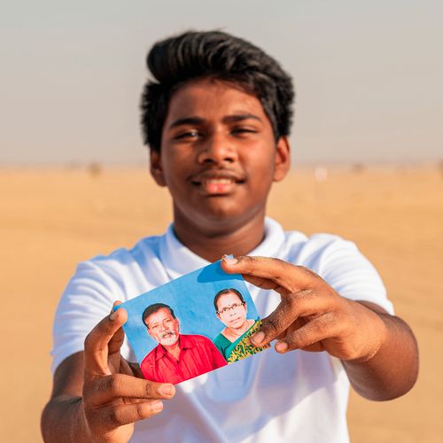 young man holding photograph of grandparents