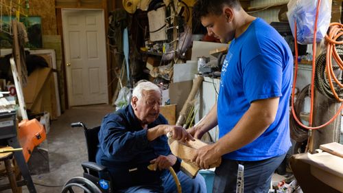 man teaching young man carpentry