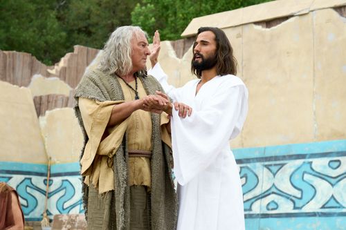 The resurrected Savior, Jesus Christ, demonstrates the proper method for baptism. Nephi stands with him during the demonstration.
