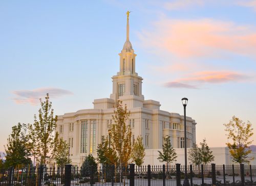 An angle view of the Payson Utah Temple during sunset, including scenery.