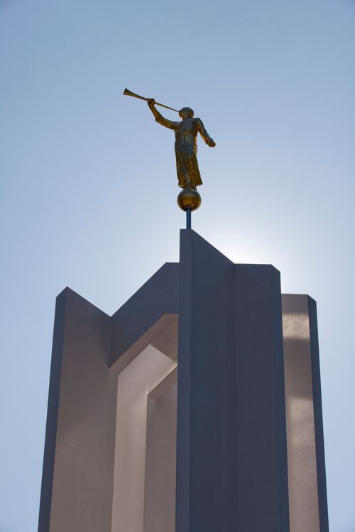 A detail shot of the Freiberg Germany Temple and angel Moroni, with a clear sky in the background.