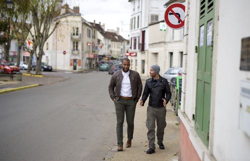 Cayo and Anthony walking around their neighborhood