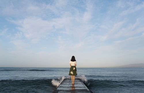 Woman standing on the end of a pier