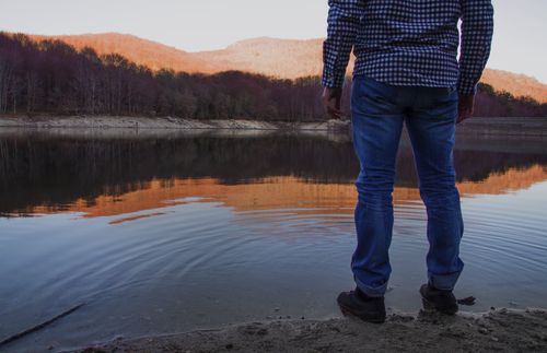 man standing by edge of water