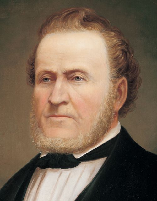 A painted portrait by George Martin Ottinger of Brigham Young in a dark suit.