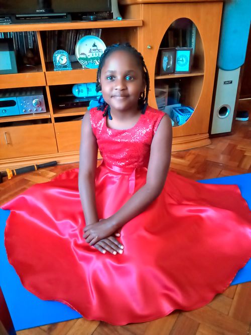 A young girl in a red dress