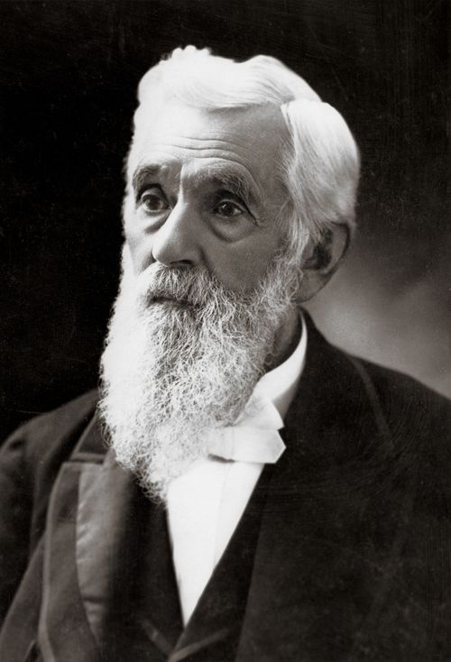 President Lorenzo Snow with white hair and a long beard, wearing a white shirt and dark suit.