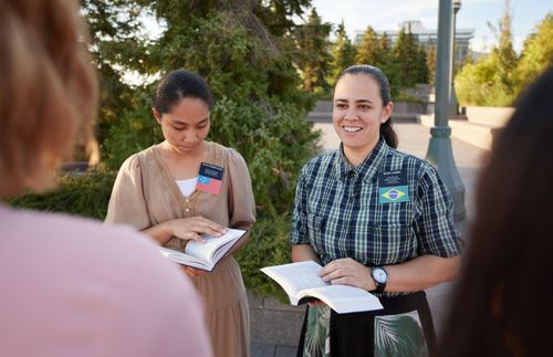 sister missionaries with open books