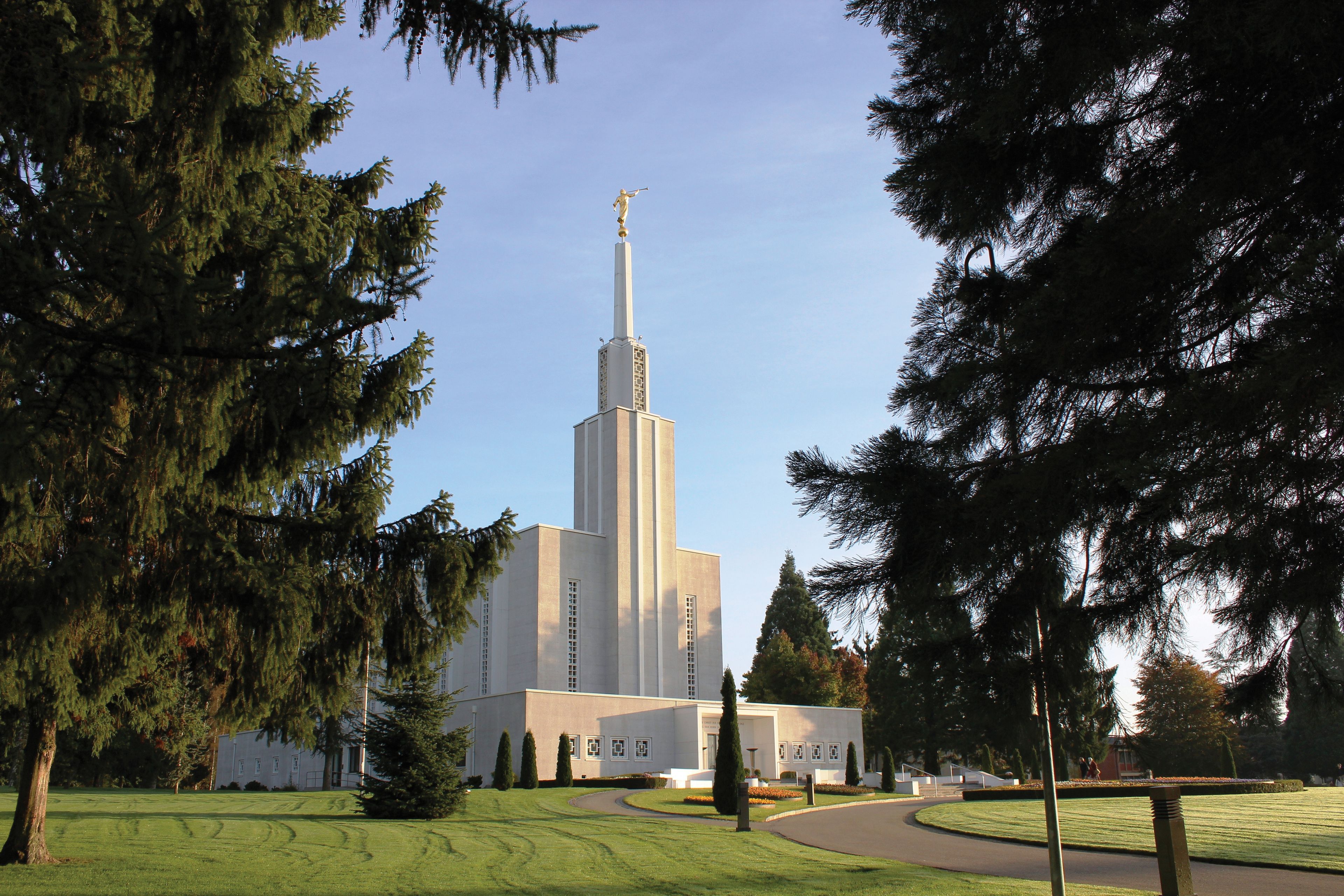 Pine trees frame a view of the Bern Switzerland Temple.