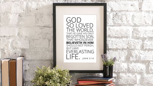 A brick wall with a framed quote from John 3:16: “God so loved the world, that he gave his only begotten Son, that whosoever believeth in him should not perish, but have everlasting life.”