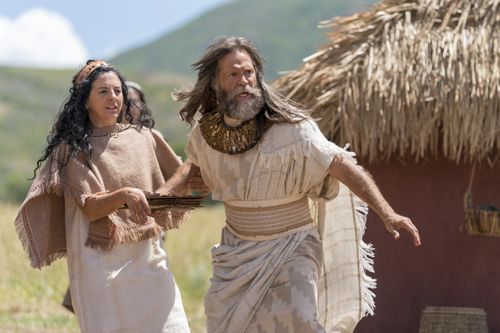 Jacob and his wife rush to help a disabled man who has been pushed by a group of Nephites.